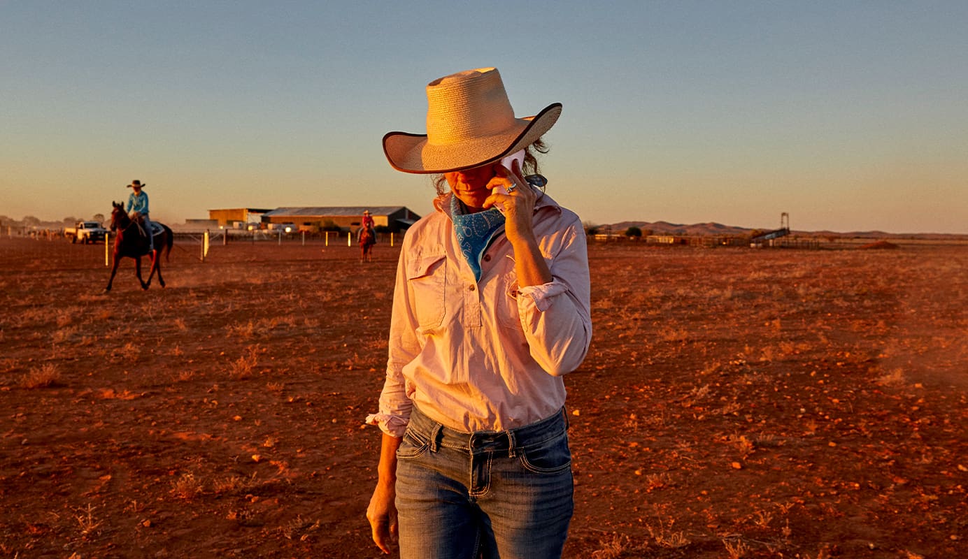Lady taking a phone call on her mobile phone using Telstra's network.